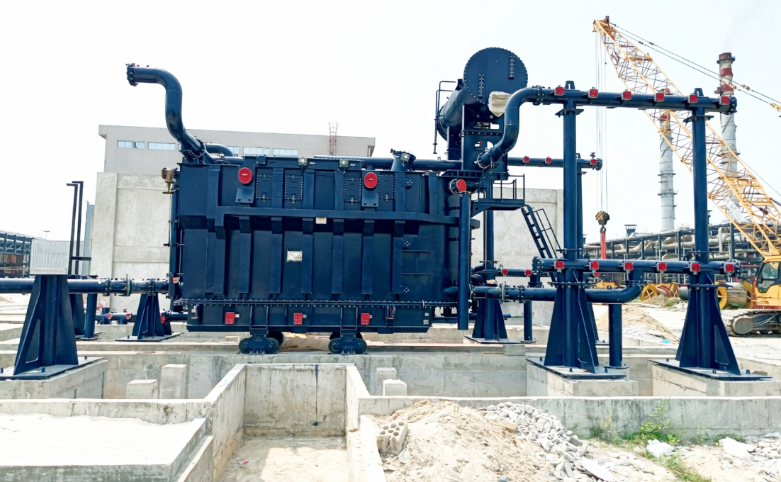 Large industrial machine with pipes and valves in an outdoor setting