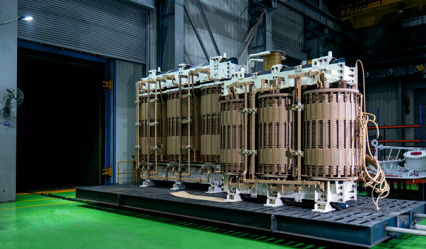 Large electrical transformer on a platform in an industrial setting