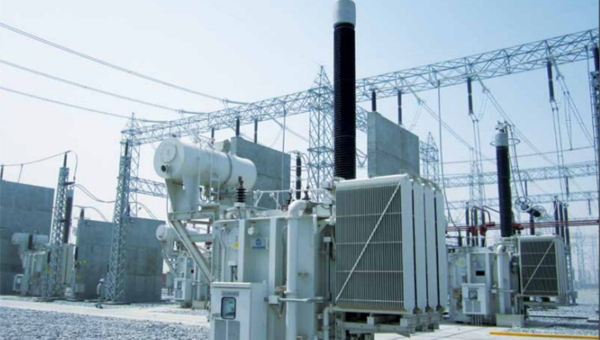 Electric power transformer station with high-voltage lines and clear sky